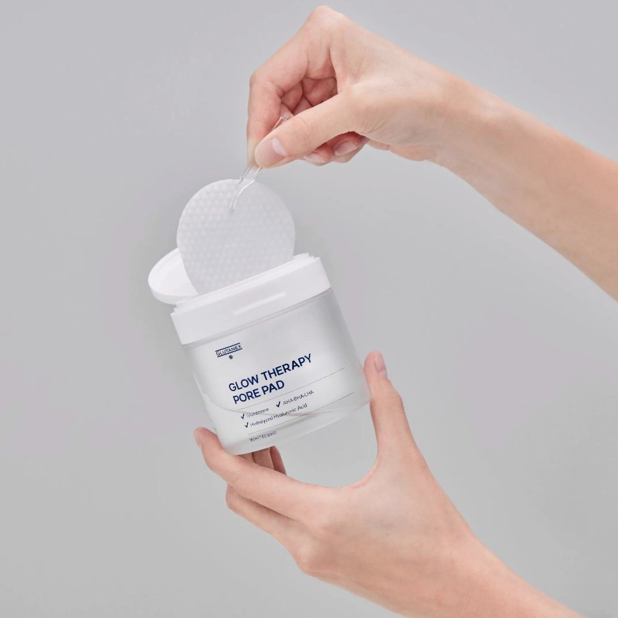 Glutanex Glow Therapy Pore Pad jar with pads and tweezers – brightening and moisturizing Korean toner pads with glutathione and triple hyaluronic acid for hydration. Formulated with AHA, BHA, and LHA to gently exfoliate dead skin and impurities, improving skin texture without irritation.