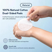 A person's hands holding and demonstrating a round white cotton exfoliating pad against a light blue background with text describing the product as 100% natural cotton dual-sided pads.